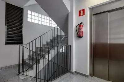 a staircase with a fire hydrant next to a door at Urban Flats Vallirana in Barcelona