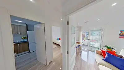 a living room with a couch and a kitchen at PREMIUM HABITAT LA RIERA in Pineda de Mar