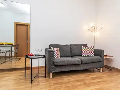 a living room with a couch and a table at Apartment Sants-Montjuïc- Avenida Madrid by Interhome in Barcelona
