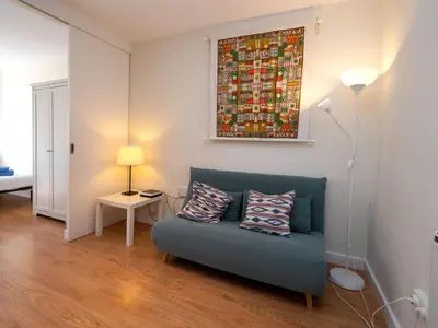 a living room with a couch and a painting on the wall at Apartment Sagrada Familia- Rossello by Interhome in Barcelona