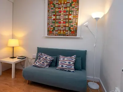 a blue couch with two pillows in a living room at Apartment Sagrada Familia- Rossello by Interhome in Barcelona
