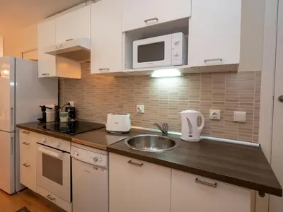 a kitchen with a sink and a microwave at Apartment Sagrada Familia- Rossello by Interhome in Barcelona