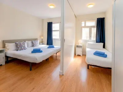 a bedroom with two beds and a mirror at Apartment Sagrada Familia- Rossello by Interhome in Barcelona