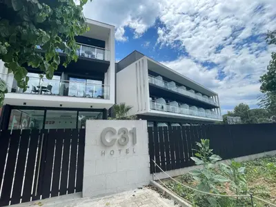 a building with a sign in front of it at Hotel C31 in Castelldefels