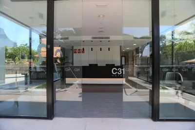 a reflection of a building in the window of a building at Hotel C31 in Castelldefels