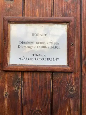a wooden door with a sign on it at Cal General in San Vicente de Castellet