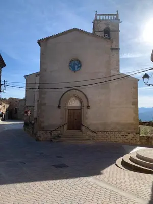a church with a clock on the front of it at Cal General in San Vicente de Castellet