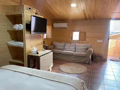 a bedroom with a bed and a couch in a room at Cal General in San Vicente de Castellet