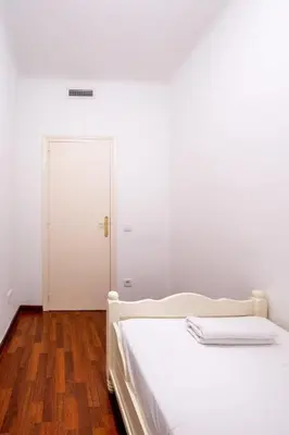 a bathroom with a white toilet in a room at The Collection Barcelona - Eixample - Bright and modern 4BD only for Families or Business groups in Barcelona