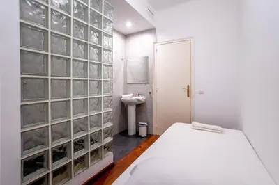 a bathroom with a glass block wall with a sink at The Collection Barcelona - Eixample - Bright and modern 4BD only for Families or Business groups in Barcelona