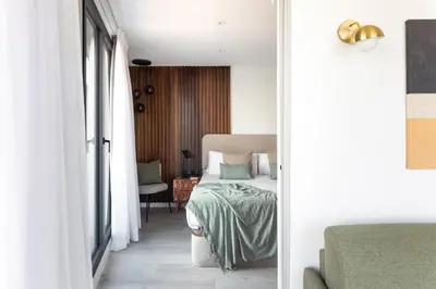 a bedroom with a bed and a chair in a room at master La Rambla in Barcelona