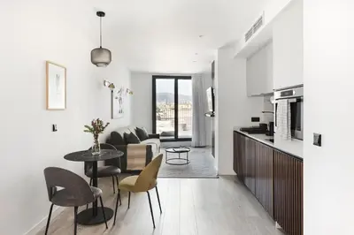 a kitchen and living room with a table and chairs at master La Rambla in Barcelona