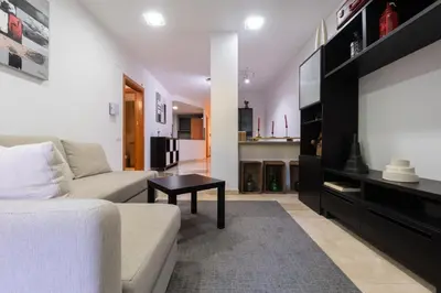 a living room with a couch and a flat screen tv at Apartament Granollers Up Live I in Granollers