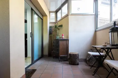 a hallway with a room with a table and windows at Apartament Granollers Up Live I in Granollers