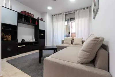 a living room with a couch and a tv at Apartament Granollers Up Live I in Granollers