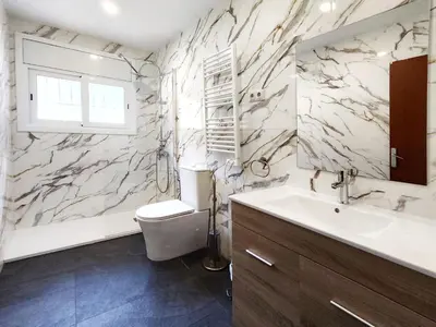 a bathroom with a toilet and a sink at Casa con piscina privada en Sant Pol de Mar in San Pol de Mar