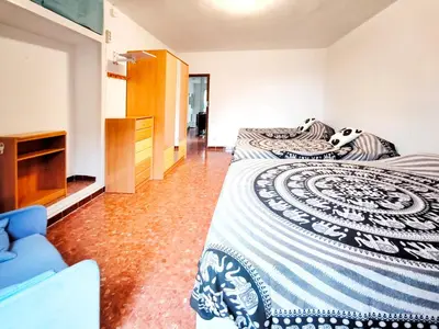 a bedroom with two beds and a tv at Casa con piscina privada en Sant Pol de Mar in San Pol de Mar