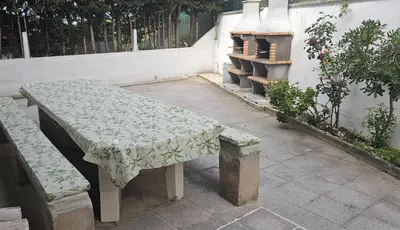 a bench with a table with a cloth on it at Casa con piscina privada en Sant Pol de Mar in San Pol de Mar