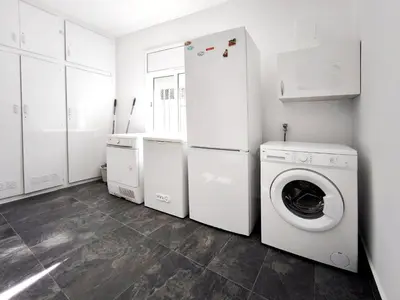 a white laundry room with a washer and dryer at Casa con piscina privada en Sant Pol de Mar in San Pol de Mar