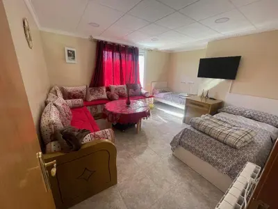 a living room with a couch and a bed at Apartamentos Atlas Terrassa V in Terrassa