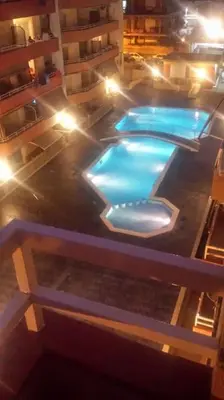 an overhead view of a swimming pool at night at New! Fantastic apartament in front of the sea! in Pineda de Mar