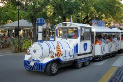 a small train with people riding in it at New! Fantastic apartament in front of the sea! in Pineda de Mar