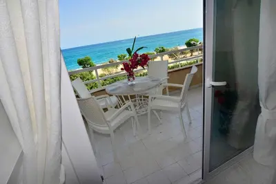 a balcony with a table and chairs and the ocean at New! Fantastic apartament in front of the sea! in Pineda de Mar