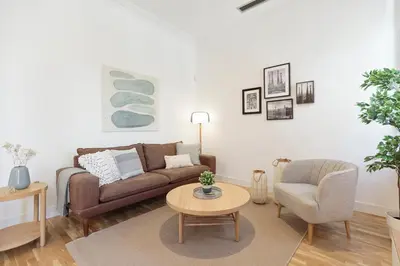 a living room with a couch and a table at Click&Flat Gaudi Dream I in Barcelona