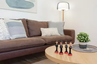 a group of figurines on a coffee table in front of a couch at Click&Flat Gaudi Dream I in Barcelona
