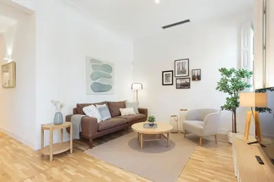 a living room with a couch and a table at Click&Flat Gaudi Dream I in Barcelona