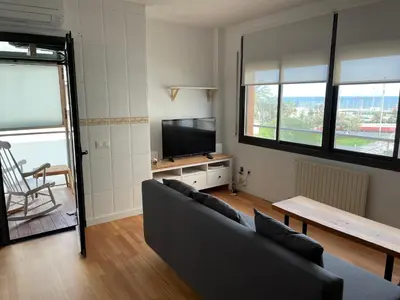 a living room with a couch and a tv at Apartment with sea views next to the beach of Mar Bella in Barcelona